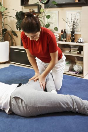 New Jersey Man Receiving Assisted Hip Stretch Physical Therapy