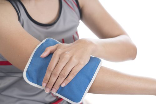 New Jersey Woman Applying Cold Compress To Elbow Pain