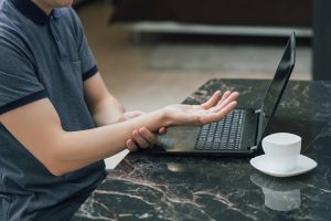 Man With Repetitive Strain Injury (RSI) Wrist Pain